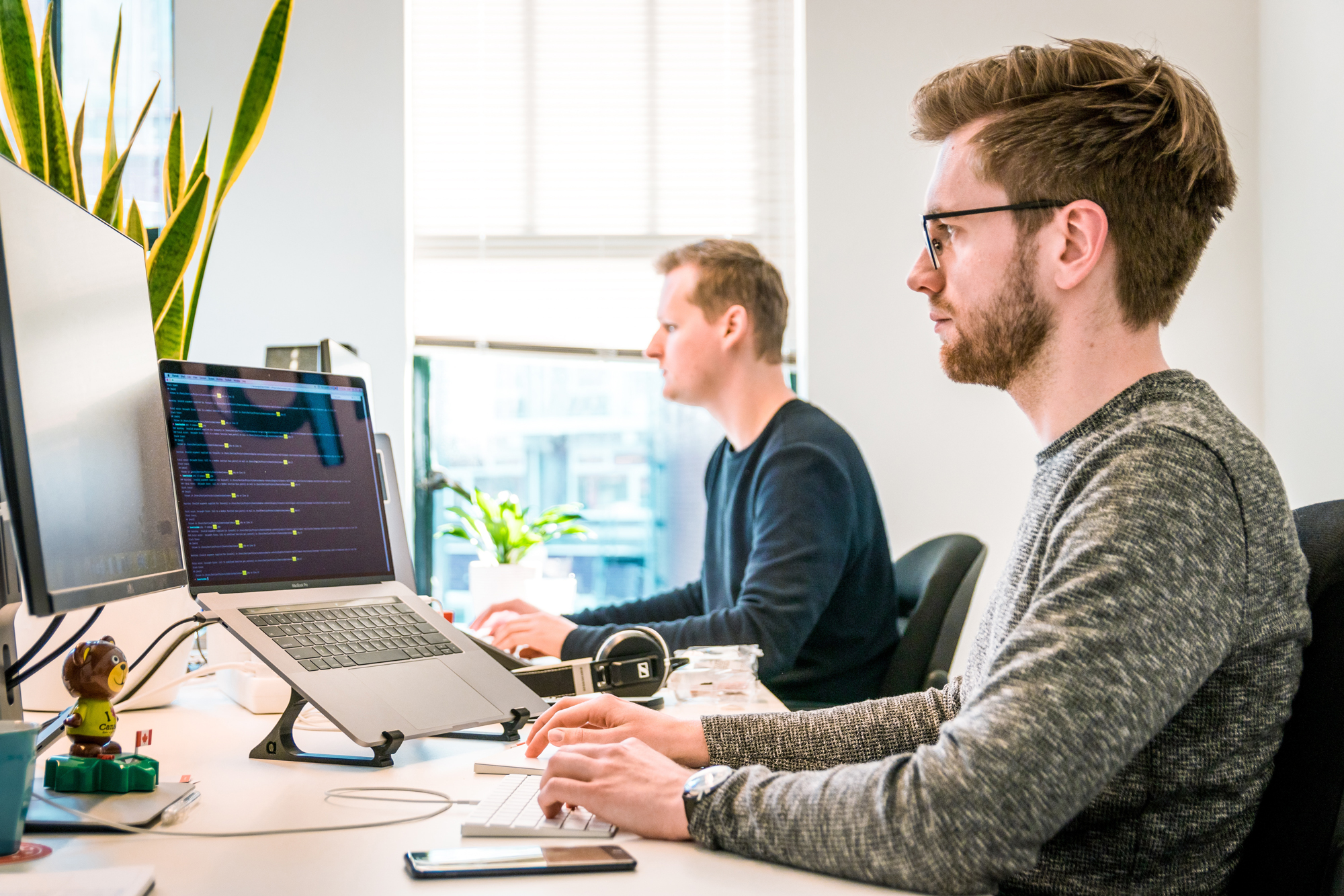 Two designers working on computers in office
