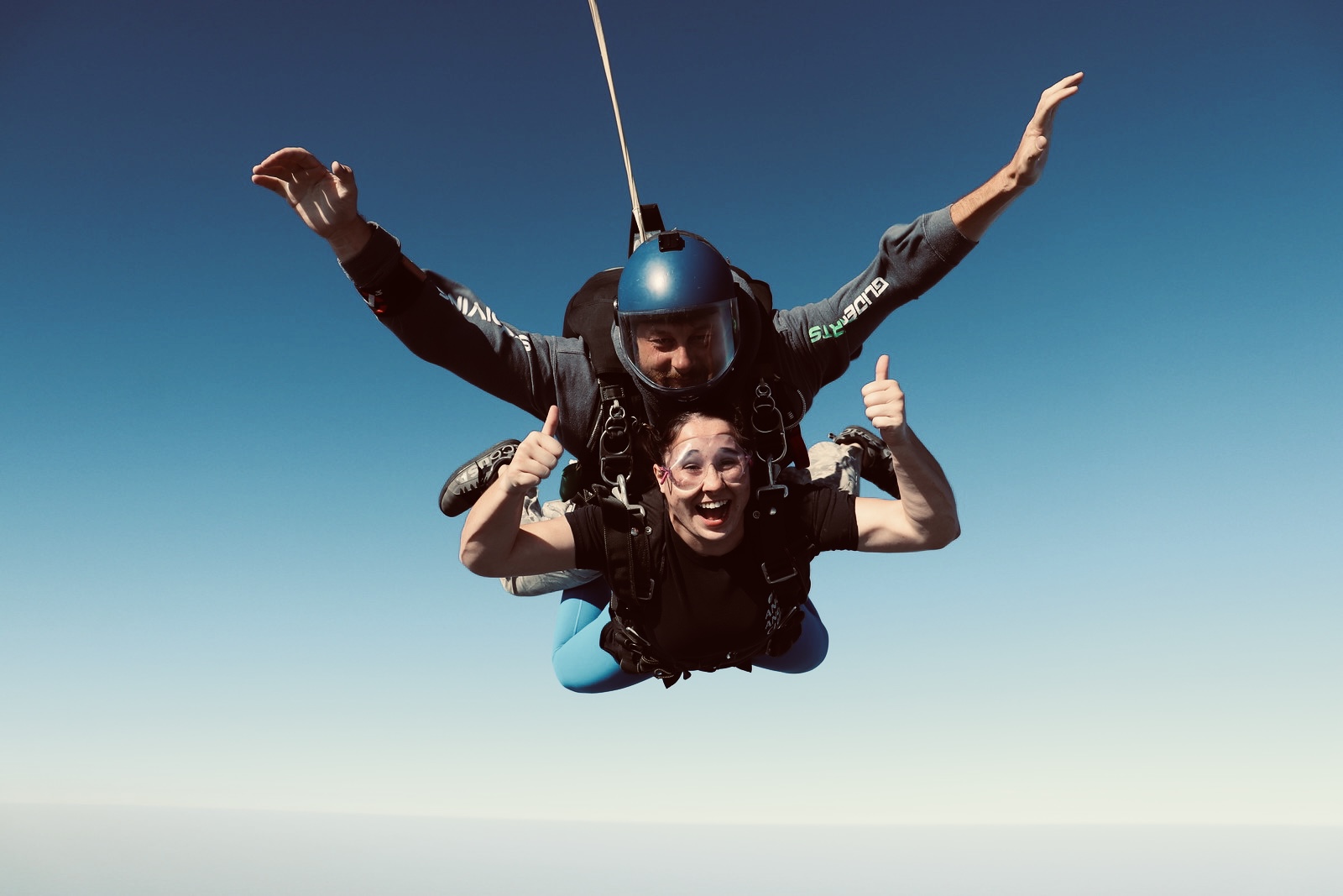 Chloe Schumacher skydiving with instructor, demonstrating initiative and a passion for adventure.