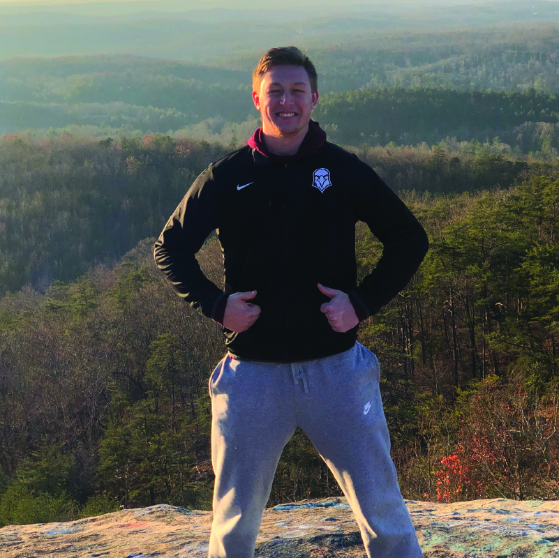 Sam Carstensen, TwoTone Creative Account Manager, smiling outdoors in Iowa.