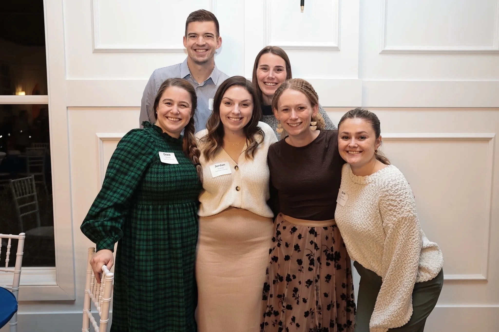 TwoTone Creative team members smiling and connecting at a company event.