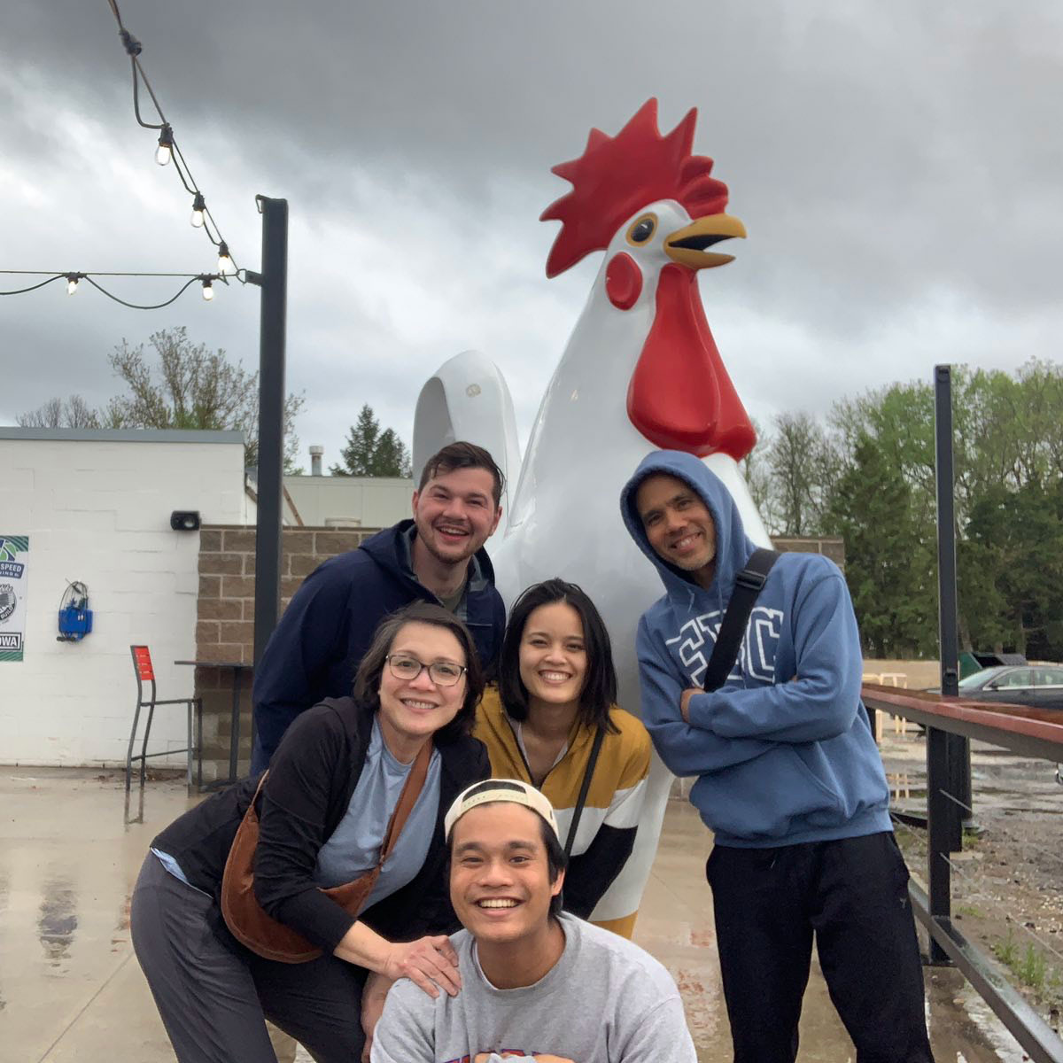 Sofia Dickens and TwoTone Creative team posing with a large chicken sculpture.