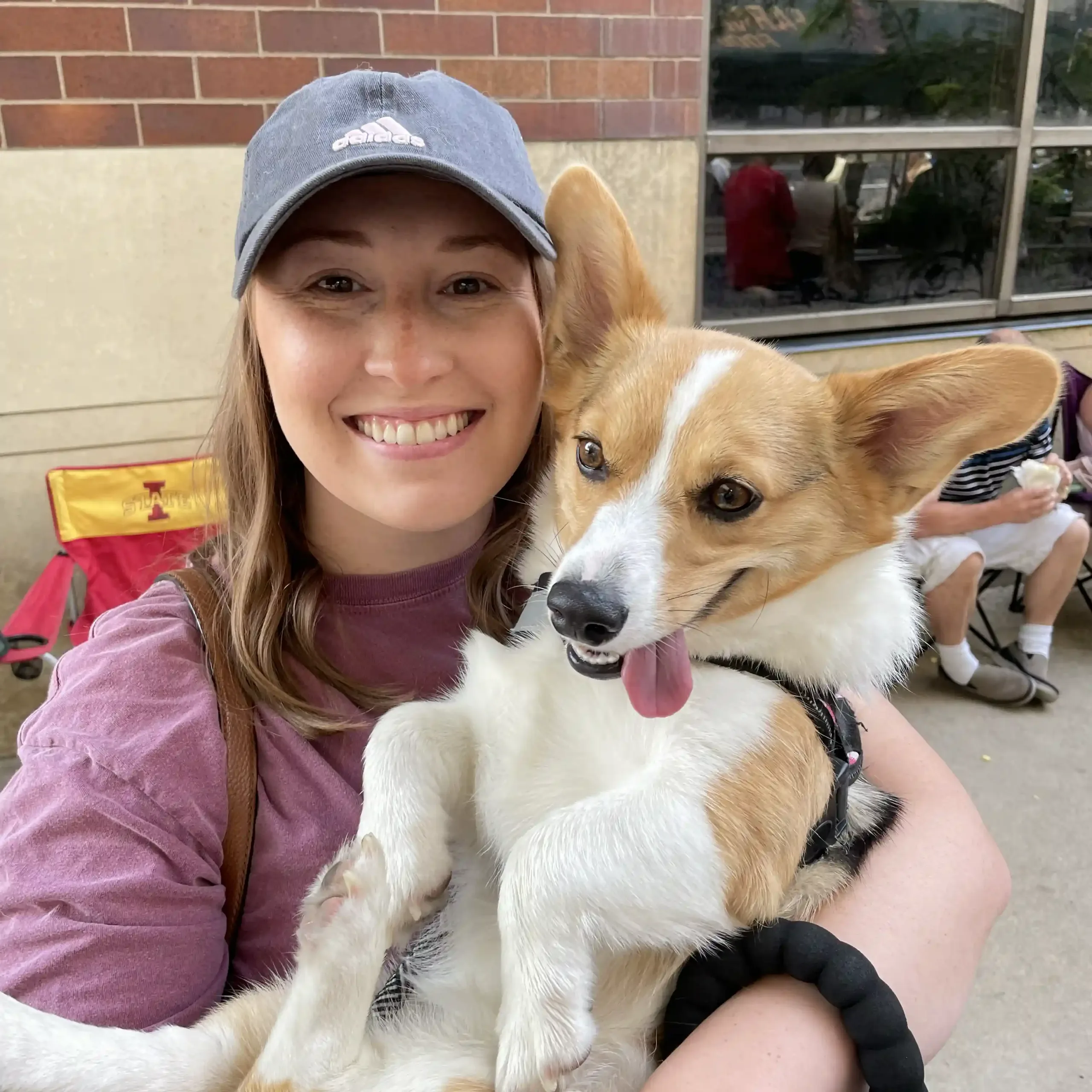Lauren Parker and her corgi, Stella, smiling together.