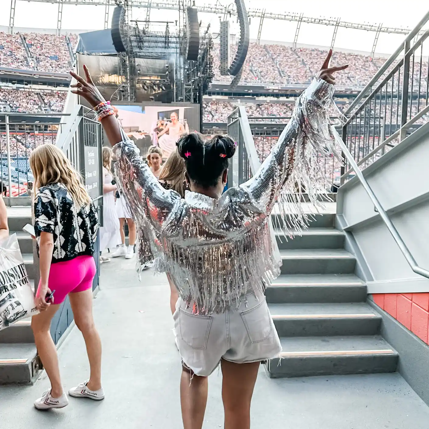 Ashlhea Demianovich at a Taylor Swift concert, celebrating with friends in a sparkly outfit.