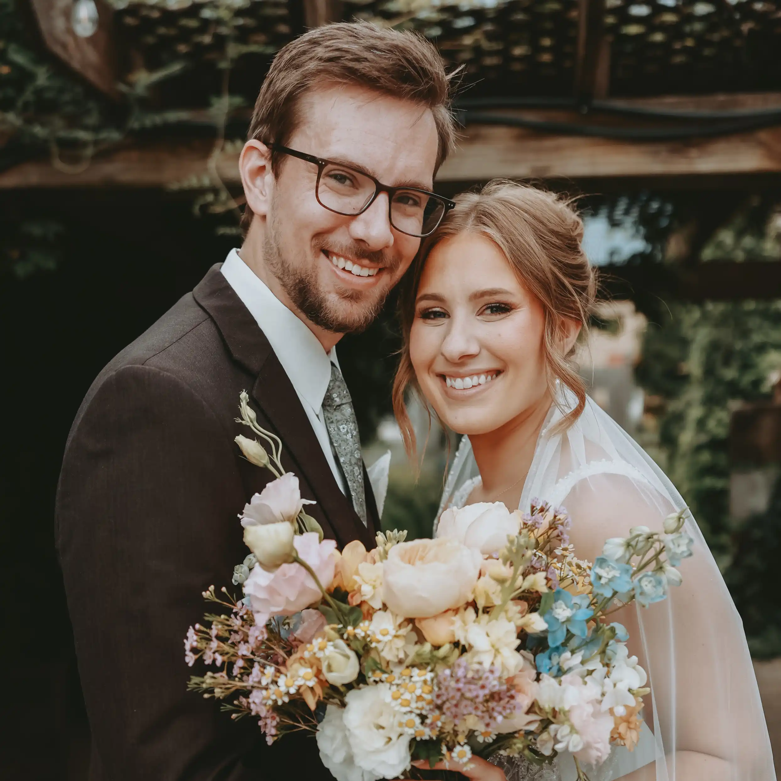 Molly Unick, graphic designer at TwoTone Creative, smiling with a bouquet of flowers.
