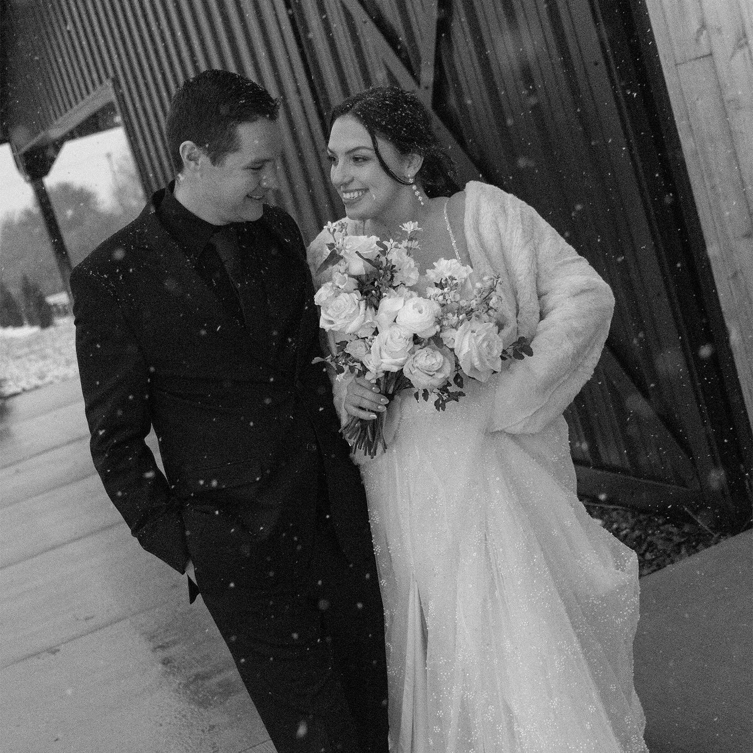 Jordan Johnson, Design Director, smiling with bouquet of flowers, black and white portrait.