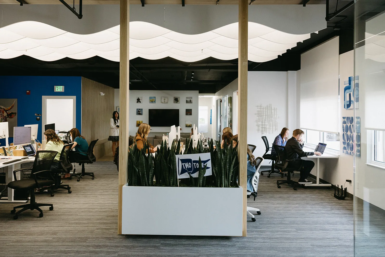 Bright TwoTone Creative office space and team members collaborating.