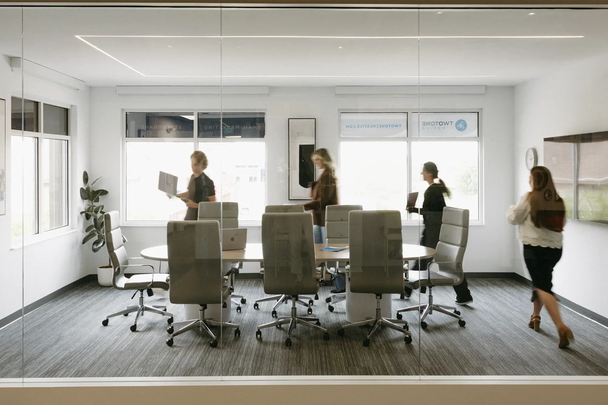 People walking and collaborating in a modern office space for marketing consultations.