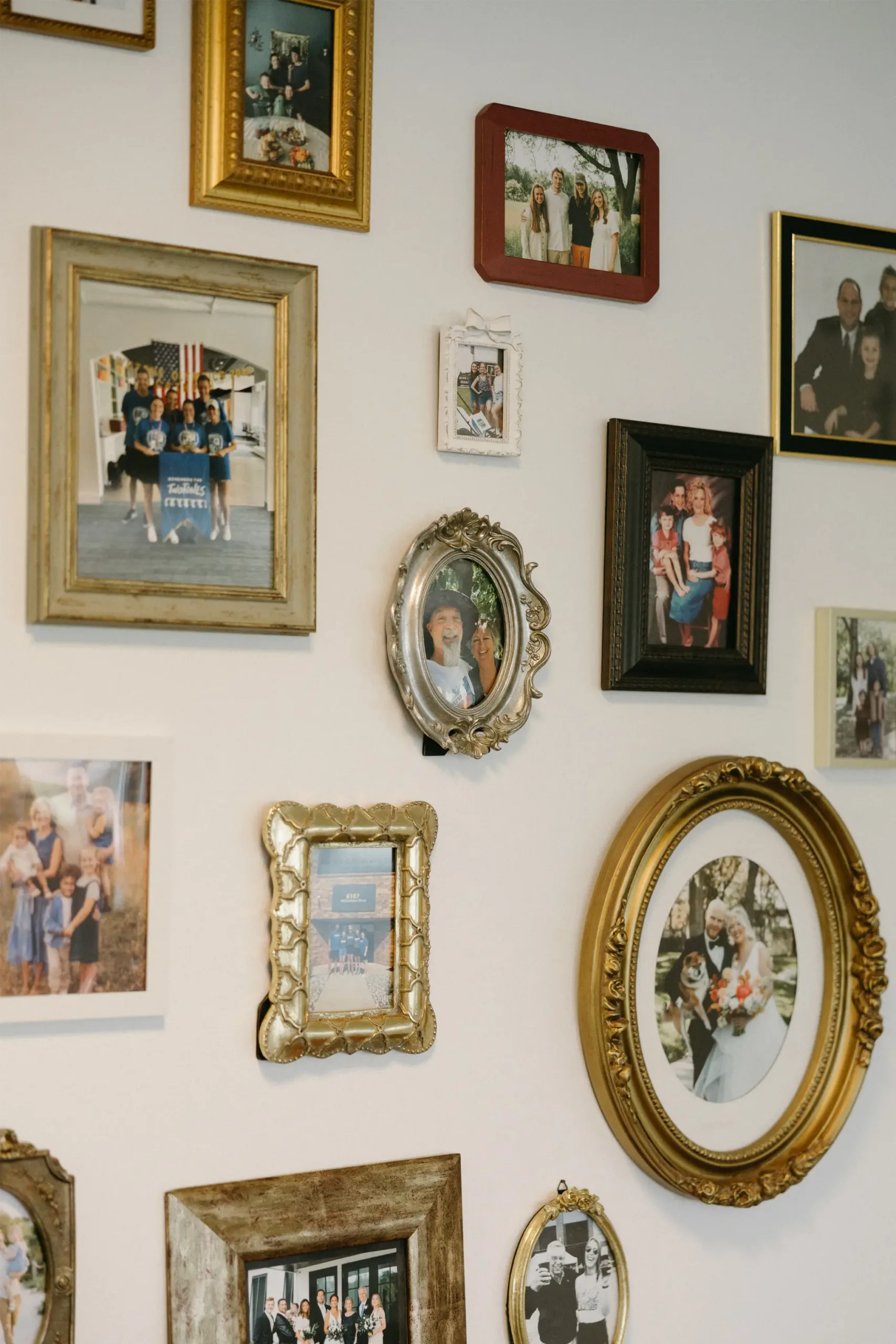 Photo wall in TwoTone Creative office showcasing team and client relationships.