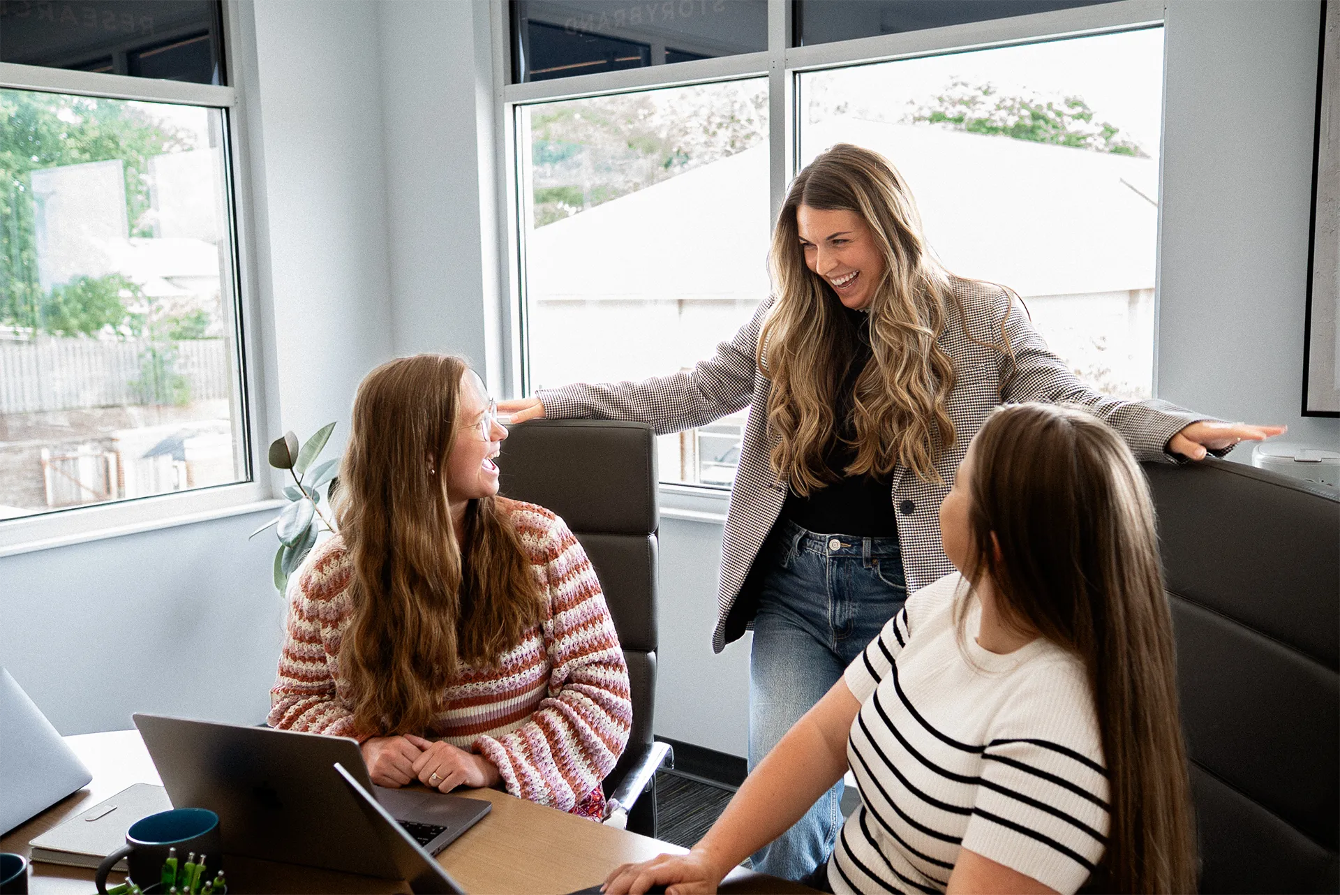 TwoTone Creative team collaborating in a bright office, demonstrating relational work environment.