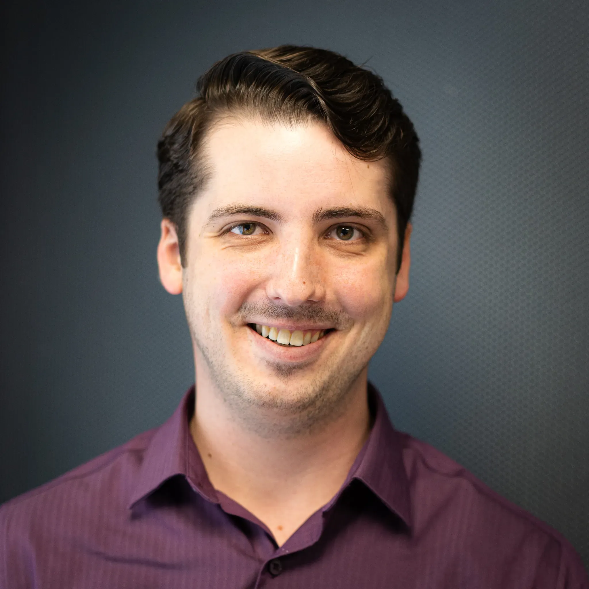 Cameron Blom, copy editor, professional headshot with a warm smile