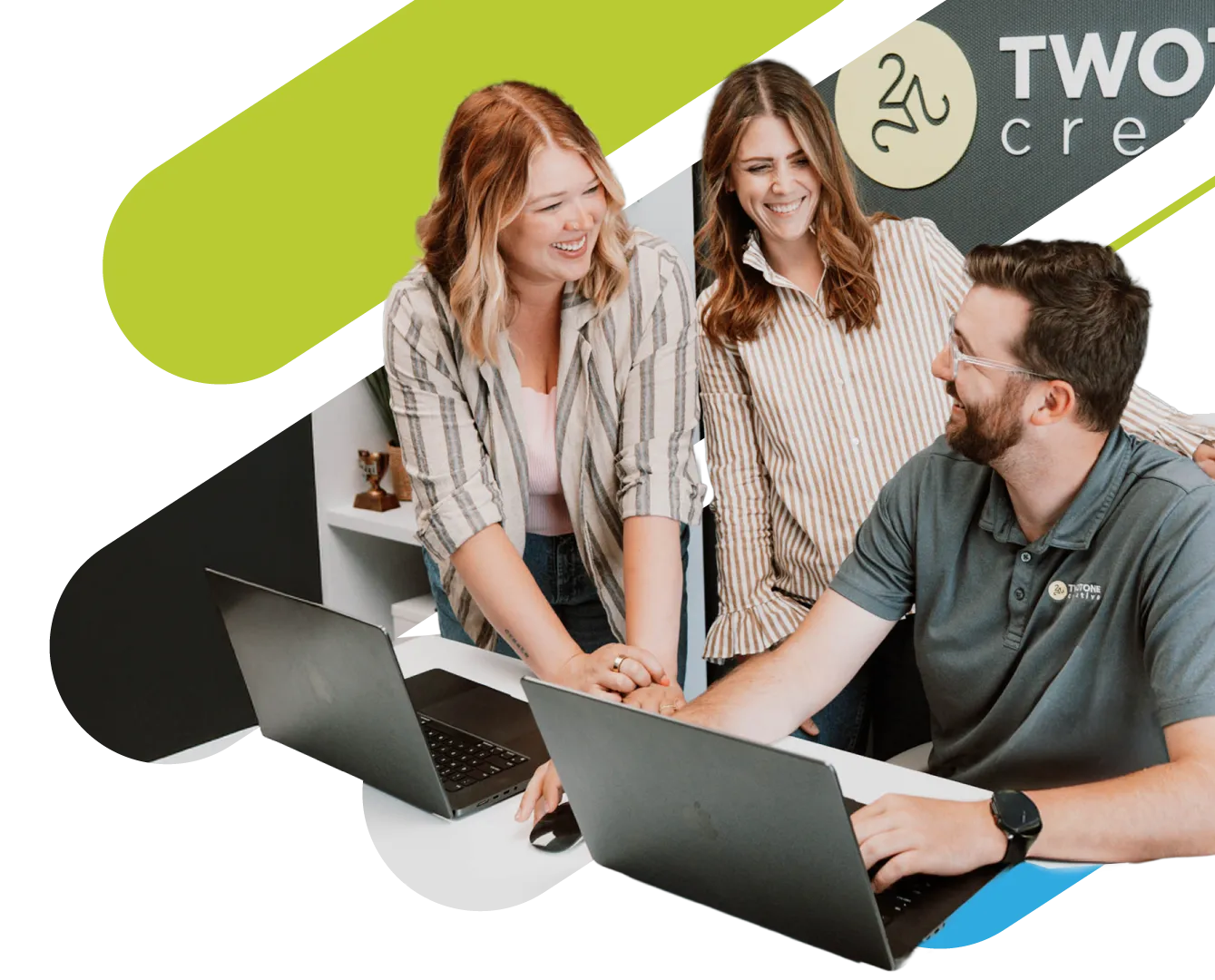 TwoTone Creative team collaborating on laptops, supporting marketing partnerships and strategy.