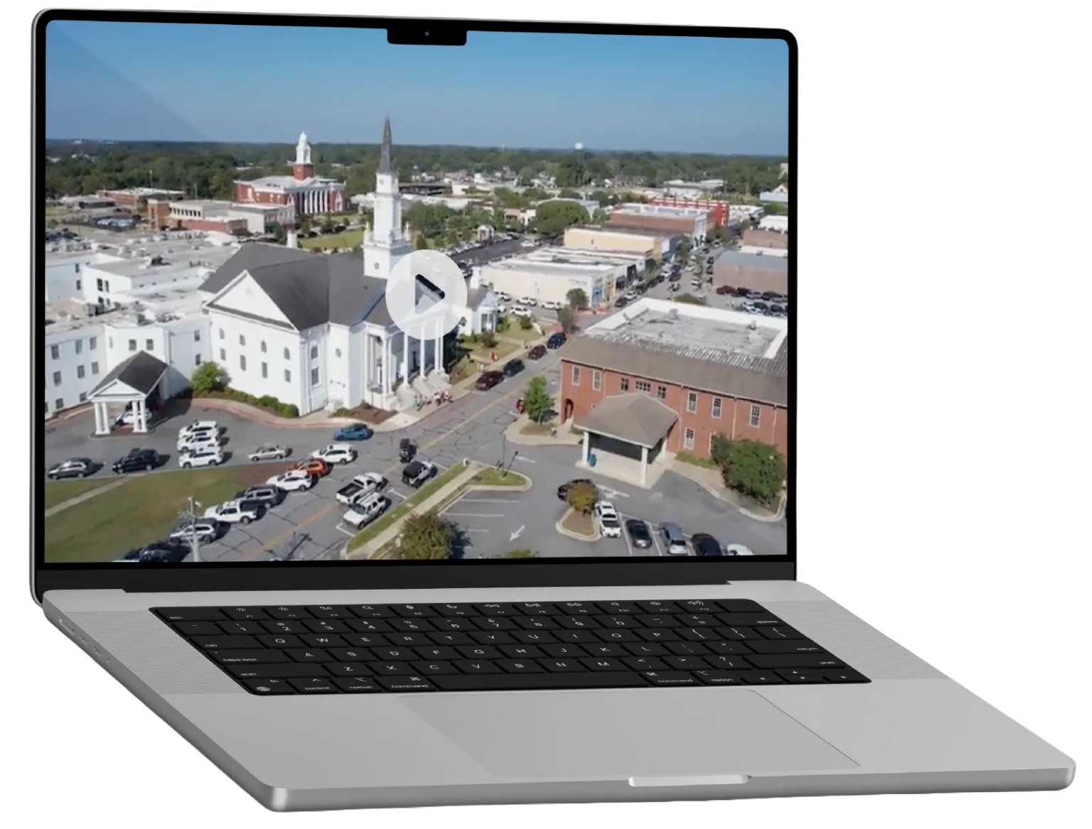 Laptop displaying aerial view of First Baptist Church of Opelika and Opelika, Alabama.