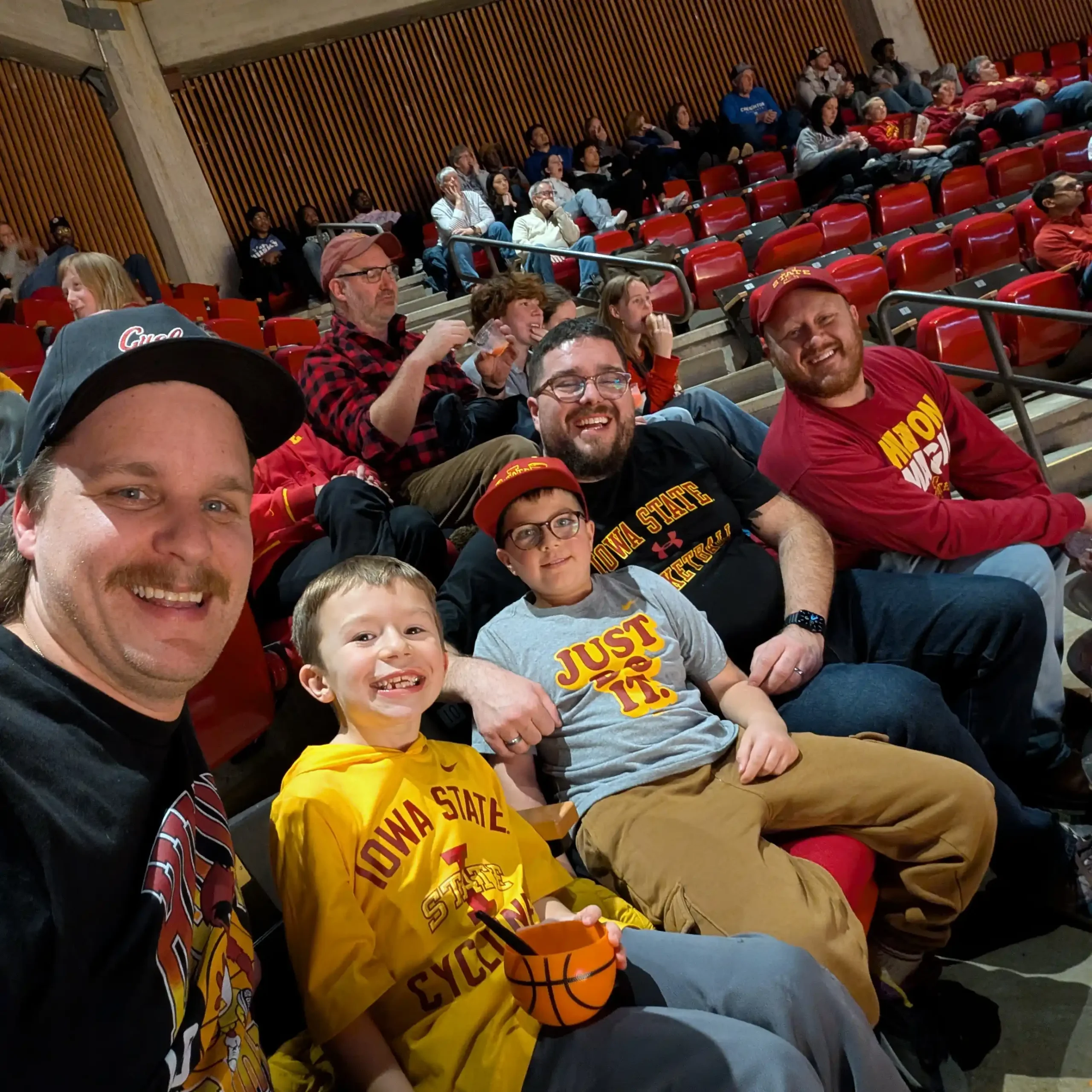 Marshall Allen and his son wearing Iowa State basketball gear at a game.